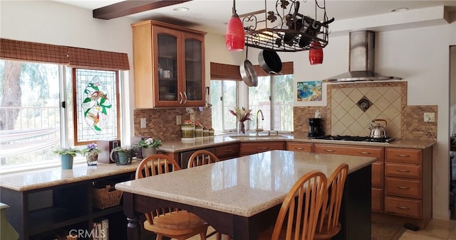 22000 Jodi Pl, Saugus, CA 91350 - kitchen featuring wall chimney range hood, gas stovetop, plenty of natural light, and backsplash