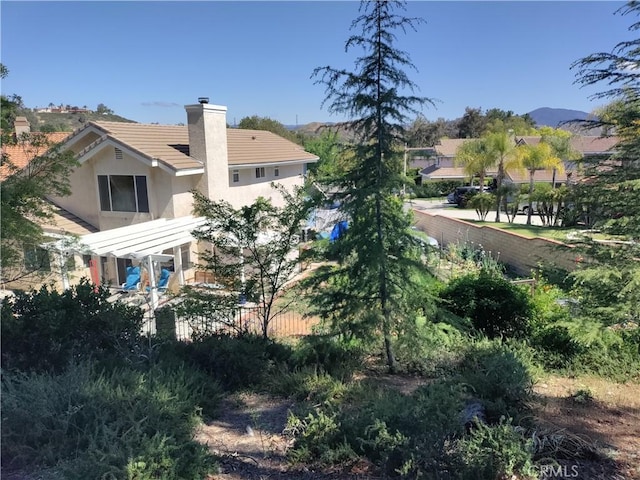 22000 Jodi Pl, Saugus, CA 91350 - back of property with stucco siding, a chimney, and a tile roof