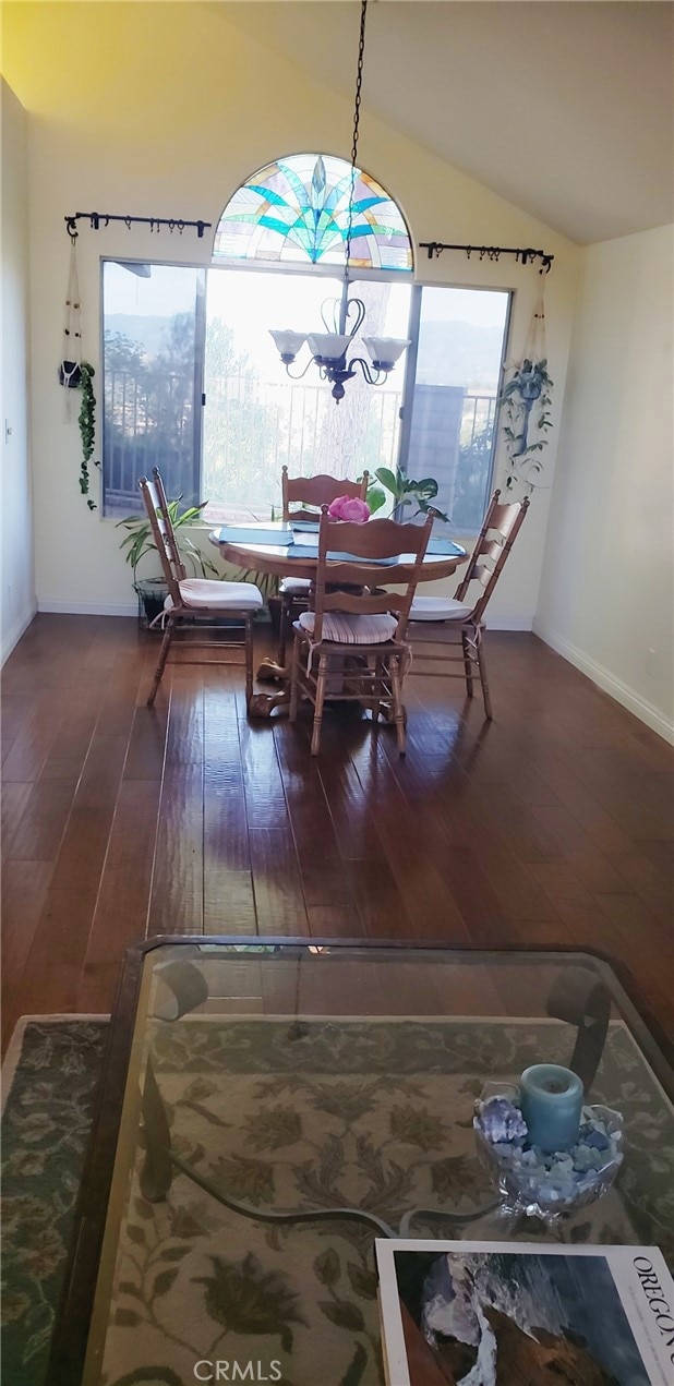 22000 Jodi Pl, Saugus, CA 91350 - dining room with lofted ceiling, wood-type flooring, and a chandelier