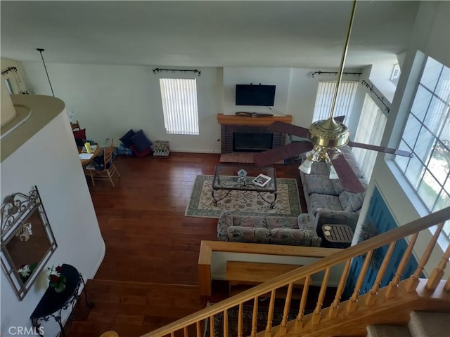 22000 Jodi Pl, Saugus, CA 91350 - living area with wood finished floors, stairway, and a brick fireplace