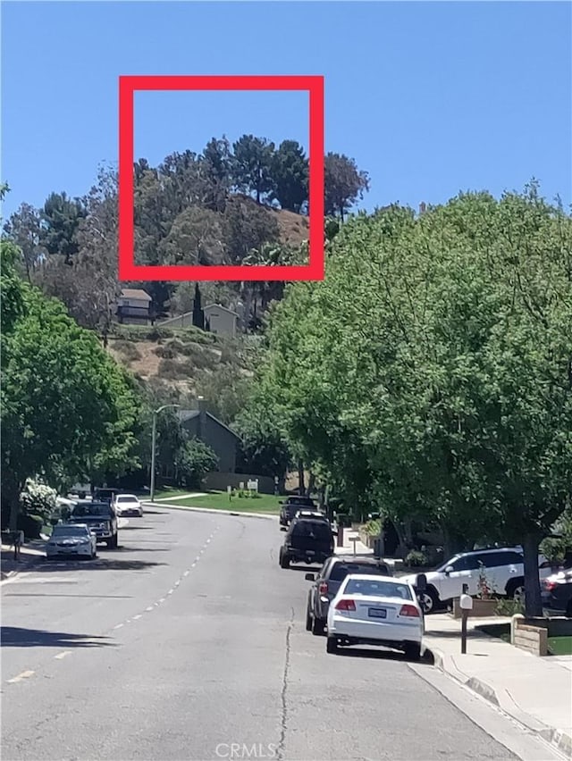 22000 Jodi Pl, Saugus, CA 91350 - view of asphalt street featuring curbs, sidewalks, and street lights