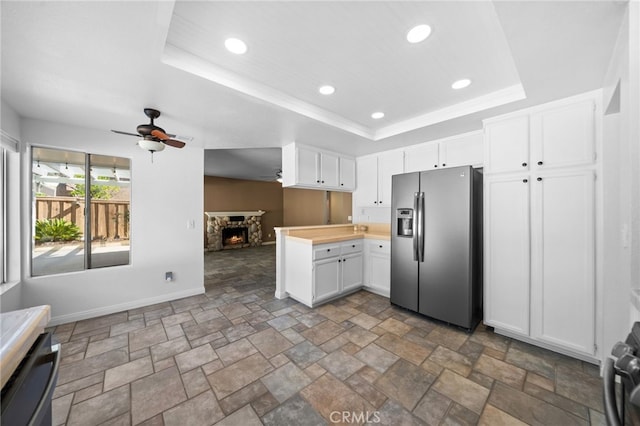 39812 Barcelona, Murrieta, CA 92562 - kitchen with stainless steel fridge, a ceiling fan, stone finish flooring, a raised ceiling, and open floor plan