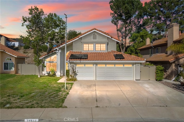 39812 Barcelona, Murrieta, CA 92562 - view of front of home with a tiled roof, concrete driveway, stucco siding, a garage, and roof mounted solar panels