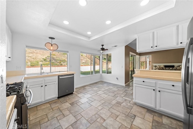 39812 Barcelona, Murrieta, CA 92562 - kitchen featuring appliances with stainless steel finishes, recessed lighting, a raised ceiling, white cabinets, and ceiling fan