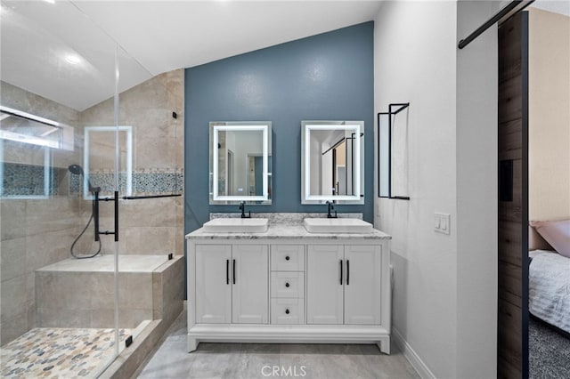 39812 Barcelona, Murrieta, CA 92562 - bathroom with a shower stall, double vanity, ensuite bath, vaulted ceiling, and baseboards