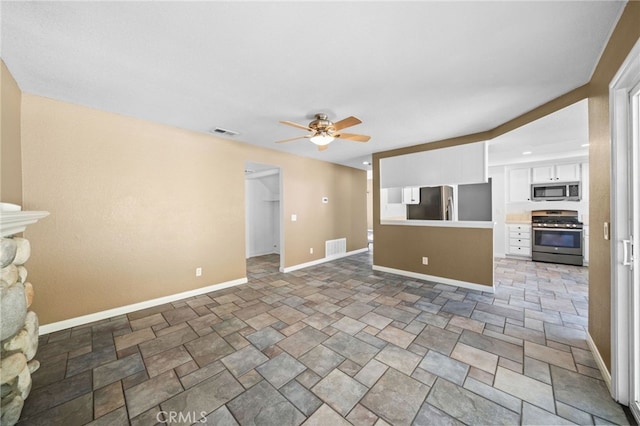 39812 Barcelona, Murrieta, CA 92562 - unfurnished living room featuring a ceiling fan, baseboards, light stone finish floors, and a fireplace