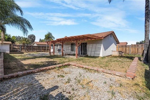 23867 Gamma St, Moreno Valley, CA 92553 - back of house with a fenced backyard, stucco siding, and a pergola