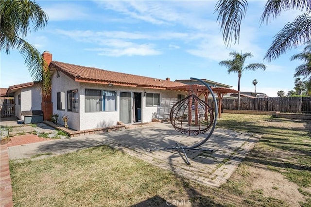23867 Gamma St, Moreno Valley, CA 92553 - back of house featuring stucco siding, a patio area, a tile roof, and a chimney