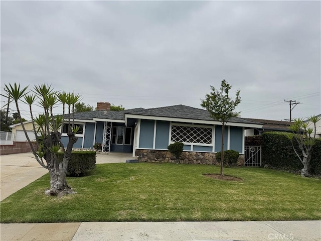 241 N 16th St N, Montebello, CA 90640 - view of front of property featuring a front lawn, a chimney, stone siding, a shingled roof, and stucco siding