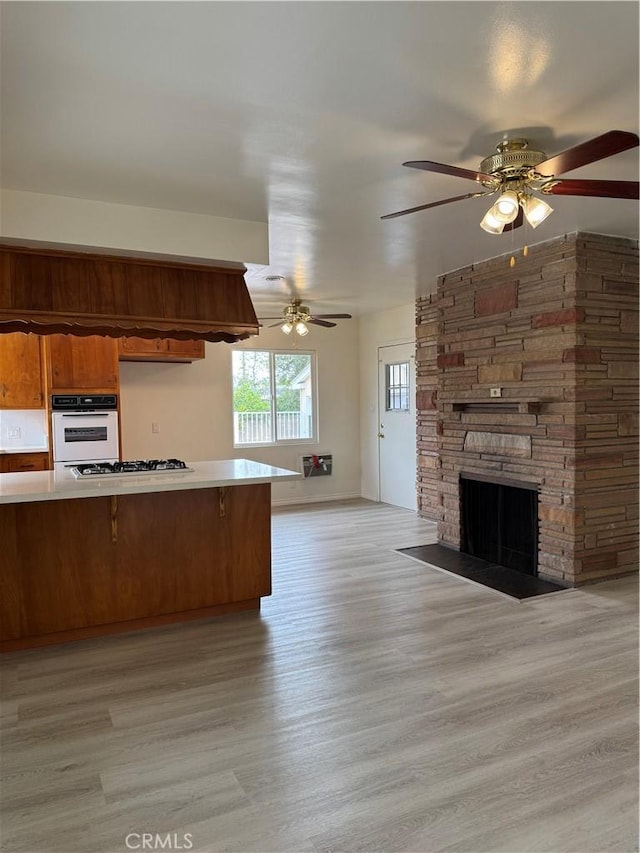 241 N 16th St N, Montebello, CA 90640 - kitchen featuring open floor plan, white oven, stovetop, light countertops, and ceiling fan