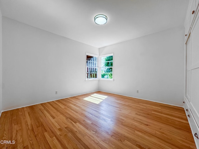 spare room featuring wood finished floors