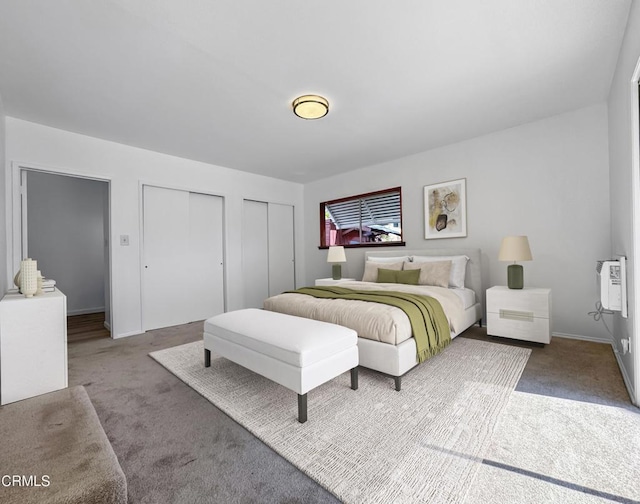 bedroom featuring two closets, carpet, and baseboards