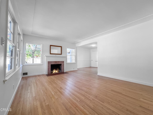 2708 Sanborn Ave, La Crescenta, CA 91214 - unfurnished living room with light wood-type flooring, baseboards, and a brick fireplace