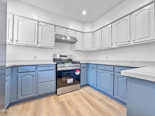2708 Sanborn Ave, La Crescenta, CA 91214 - kitchen featuring gas stove, under cabinet range hood, blue cabinetry, light wood finished floors, and white cabinets