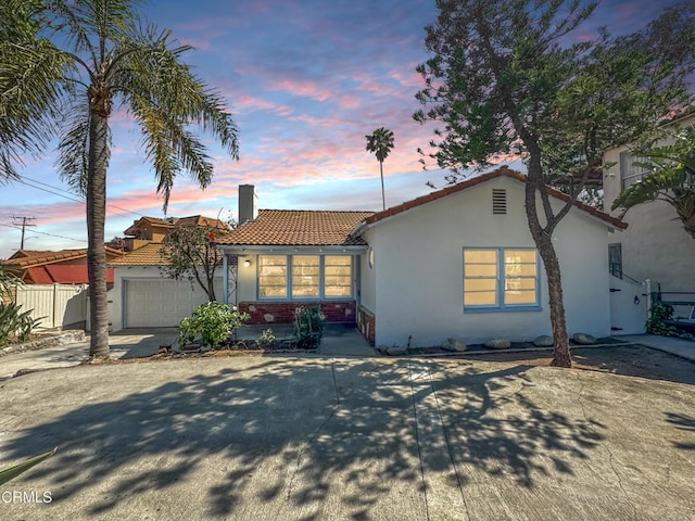 2708 Sanborn Ave, La Crescenta, CA 91214 - mediterranean / spanish home with a tiled roof, a chimney, stucco siding, a garage, and fence