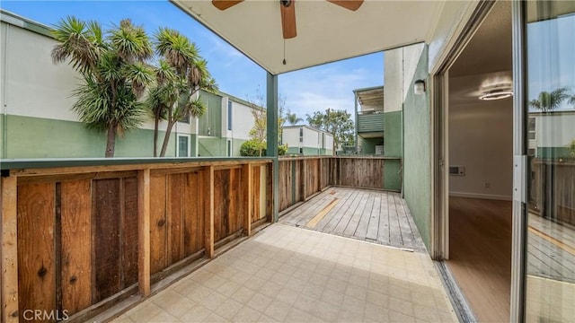 view of wooden balcony featuring a ceiling fan and a deck