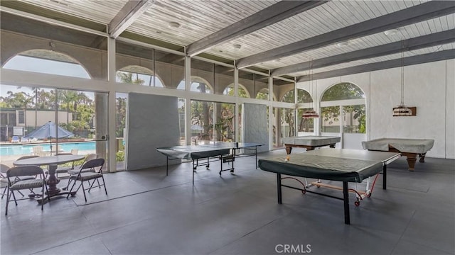 sunroom / solarium with beam ceiling, plenty of natural light, and billiards table