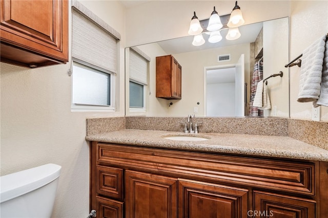 6329 Fillmore Ave, Rialto, CA 92377 - bathroom featuring toilet, vanity, and a chandelier