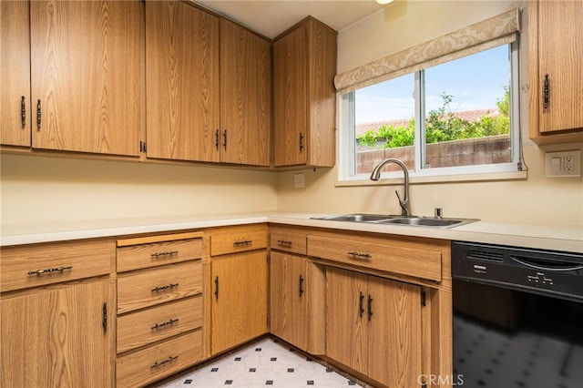 6329 Fillmore Ave, Rialto, CA 92377 - kitchen with black dishwasher, a sink, light countertops, and brown cabinetry