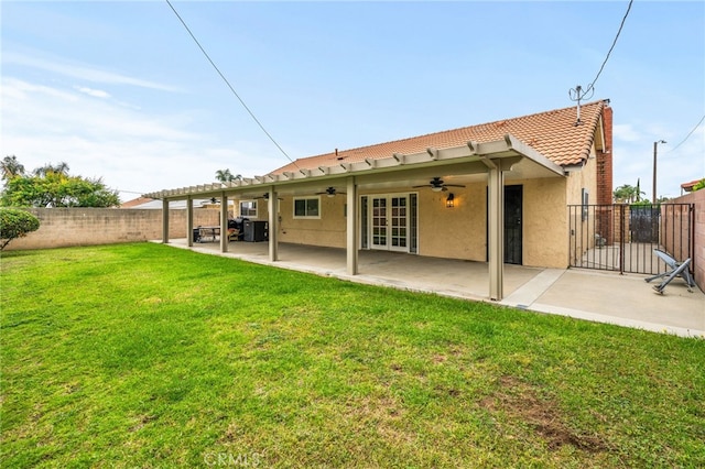6329 Fillmore Ave, Rialto, CA 92377 - rear view of house featuring a ceiling fan, a tiled roof, french doors, stucco siding, and a patio area