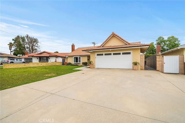6329 Fillmore Ave, Rialto, CA 92377 - ranch-style home featuring a gate, stucco siding, a tiled roof, driveway, and an attached garage