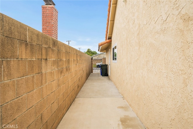 6329 Fillmore Ave, Rialto, CA 92377 - view of property exterior featuring stucco siding and a chimney
