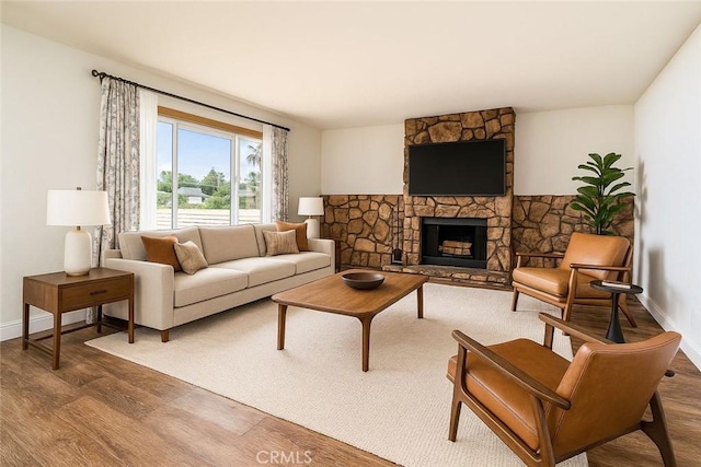 6329 Fillmore Ave, Rialto, CA 92377 - living room with wood finished floors, baseboards, and a fireplace
