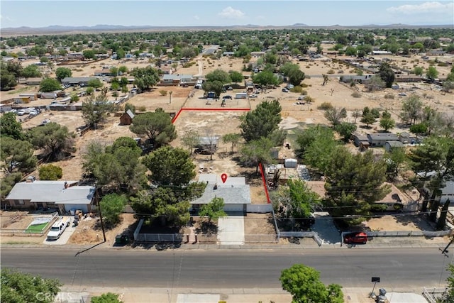 aerial view of property's location featuring a mountain backdrop, property parcel outlined, and a desert landscape