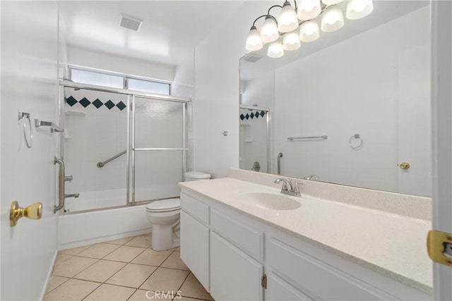 bathroom with toilet, tile patterned floors, vanity, and combined bath / shower with glass door