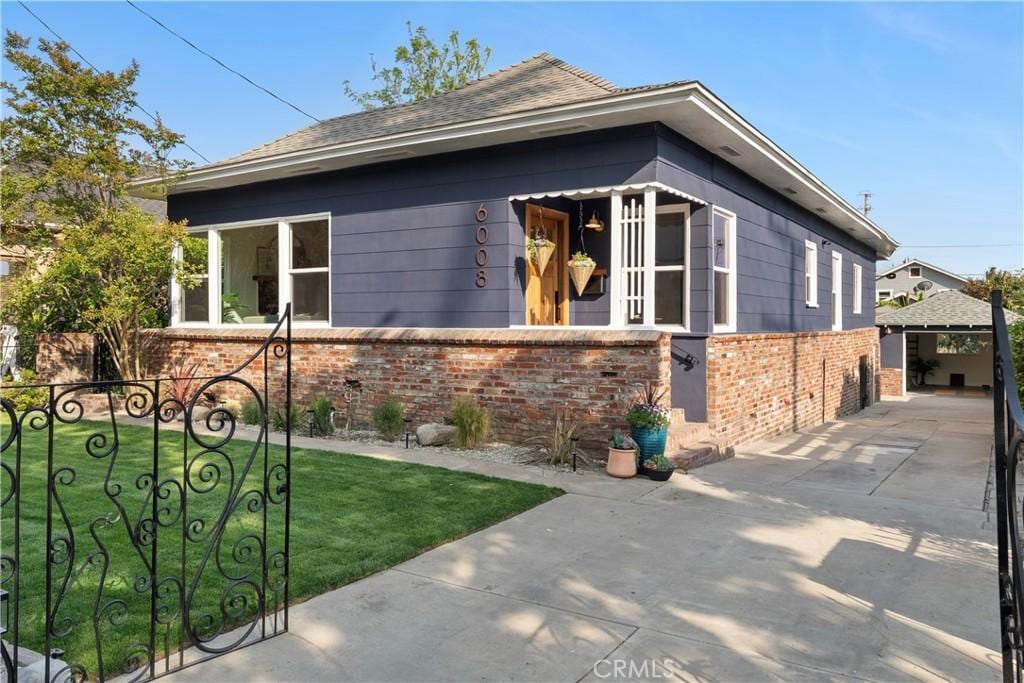 6008 Monte Vista St, Los Angeles, CA 90042 - view of side of home featuring brick siding and an outdoor structure