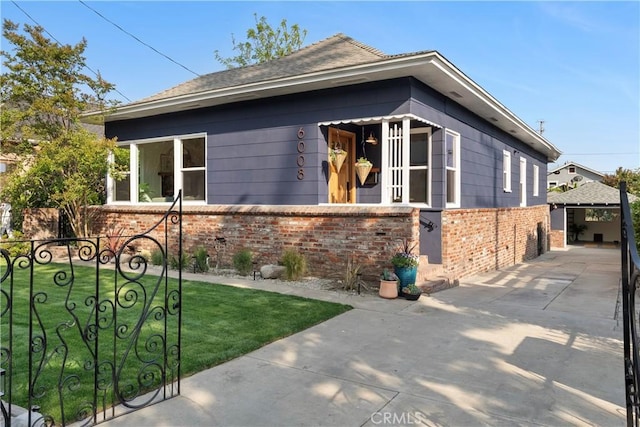 6008 Monte Vista St, Los Angeles, CA 90042 - view of side of home featuring brick siding and an outdoor structure