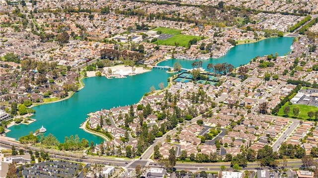 aerial view of property's location with a large body of water and nearby suburban area
