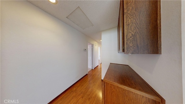 279 White Oak Rd, Lake Elsinore, CA 92530 - hallway featuring attic access, light wood finished floors, and a textured ceiling