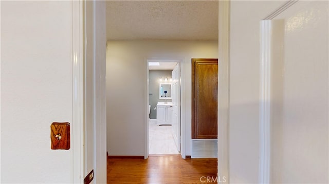 279 White Oak Rd, Lake Elsinore, CA 92530 - hallway with wood finished floors, baseboards, and a textured ceiling
