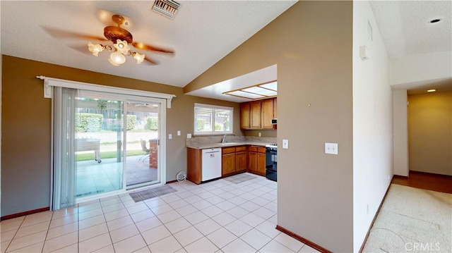 279 White Oak Rd, Lake Elsinore, CA 92530 - kitchen with dishwasher, lofted ceiling, black range with gas cooktop, light countertops, and brown cabinetry