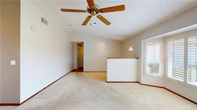 279 White Oak Rd, Lake Elsinore, CA 92530 - carpeted spare room featuring a textured ceiling, baseboards, ceiling fan, and lofted ceiling