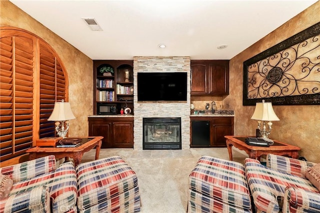 6723 Sycamore Ln, Palmdale, CA 93551 - living room featuring a stone fireplace, carpet floors, and built in features