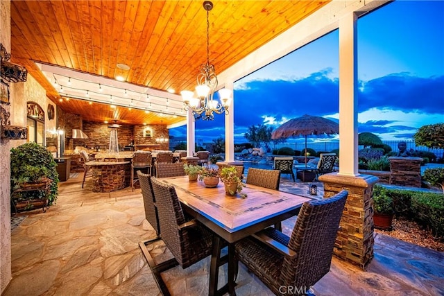 6723 Sycamore Ln, Palmdale, CA 93551 - dining space with wooden ceiling, stone floors, and a chandelier