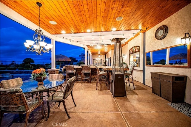 6723 Sycamore Ln, Palmdale, CA 93551 - dining space featuring a textured wall, wood ceiling, rail lighting, a chandelier, and concrete floors