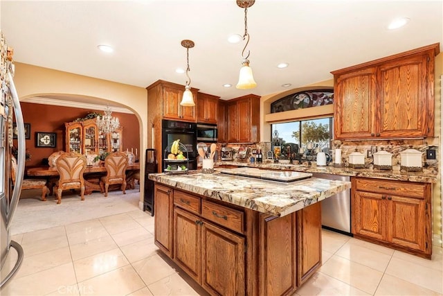 6723 Sycamore Ln, Palmdale, CA 93551 - kitchen featuring arched walkways, stainless steel appliances, brown cabinets, a kitchen island, and recessed lighting