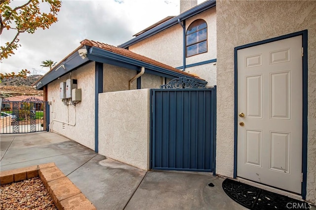 6723 Sycamore Ln, Palmdale, CA 93551 - view of exterior entry featuring a gate, stucco siding, and fence