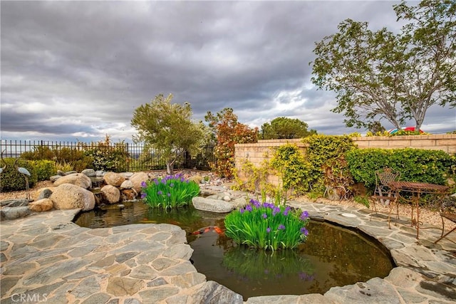 6723 Sycamore Ln, Palmdale, CA 93551 - fenced backyard featuring a garden pond