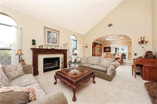 6723 Sycamore Ln, Palmdale, CA 93551 - carpeted living area with a chandelier, arched walkways, high vaulted ceiling, plenty of natural light, and a fireplace