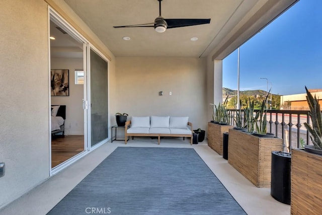 balcony featuring a ceiling fan and a mountain view