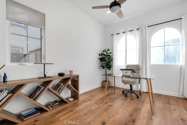 office featuring healthy amount of natural light, ceiling fan, wood finished floors, and recessed lighting