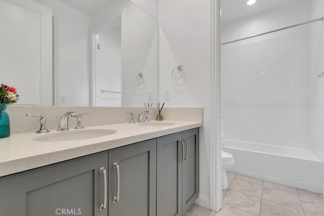 bathroom with toilet, double vanity, tub / shower combination, tile patterned flooring, and recessed lighting
