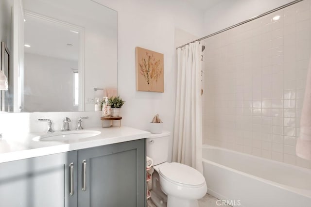 bathroom with toilet, vanity, and shower / bathtub combination with curtain