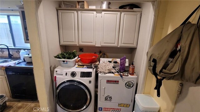 clothes washing area with washer and clothes dryer and a sink