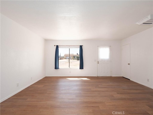 unfurnished room featuring wood finished floors and baseboards