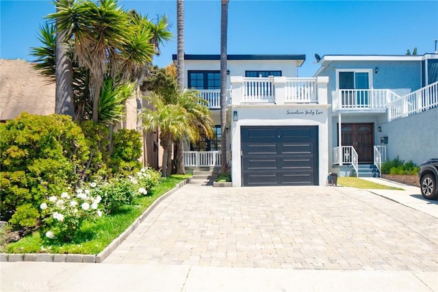 1742 Dixon St, Redondo Beach, CA 90278 - coastal home featuring a balcony, decorative driveway, stucco siding, and an attached garage
